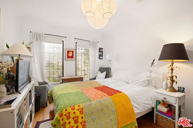 a bedroom with a bed and a flat screen tv