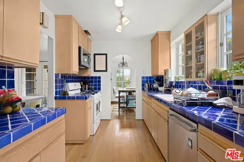 a kitchen with stainless steel appliances granite countertop a stove and cabinets