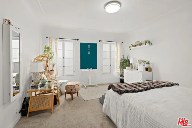 a bedroom with a bed couch and window