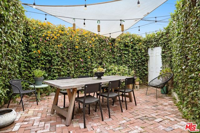 a backyard of a house with table and chairs