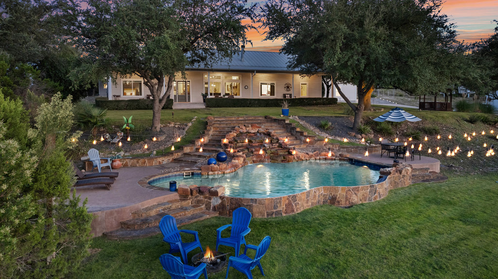 4607 R O Drive Spicewood, TX 78669 - Photo 1 of 40 a view of a swimming pool with sitting area