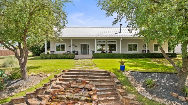 a view of house with outdoor space and swimming pool