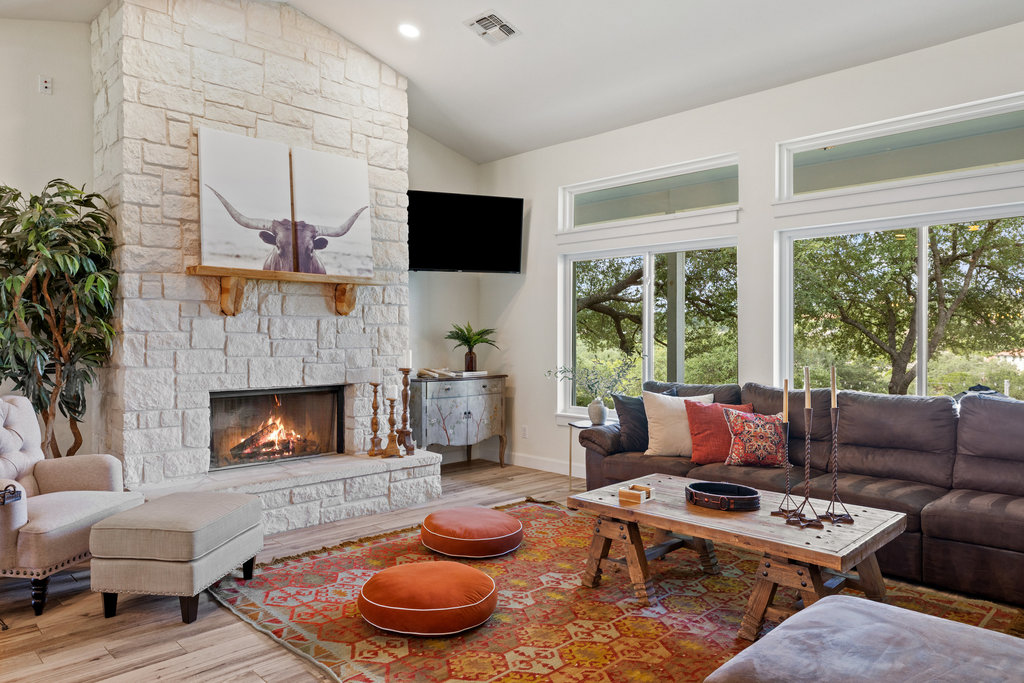 4607 R O Drive Spicewood, TX 78669 - Photo 13 of 40 a living room with furniture a fireplace and a large window