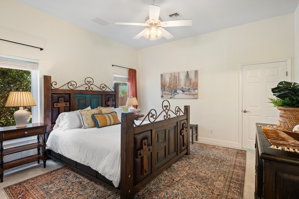 4607 R O Drive Spicewood, TX 78669 - Photo 19 of 40 a bed room with bed and a chandelier