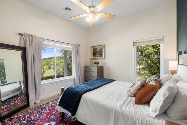 a bedroom with a large bed and a flat tv screen