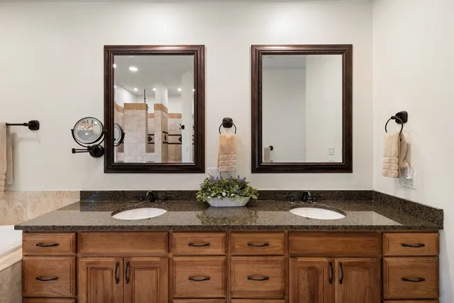 a bathroom with double sink and a mirror
