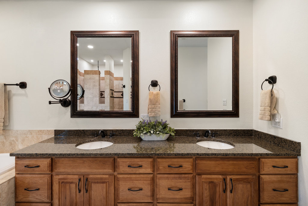 4607 R O Drive Spicewood, TX 78669 - Photo 23 of 40 a bathroom with double sink and a mirror