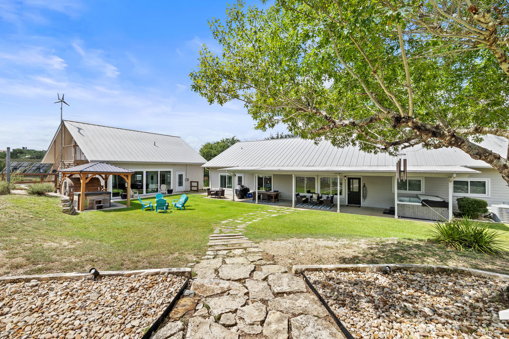 4607 R O Drive Spicewood, TX 78669 - Photo 27 of 40 a front view of a house with a garden