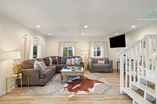 a living room with furniture and a flat screen tv