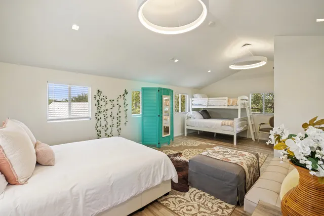 a bedroom with a bed and a chandelier