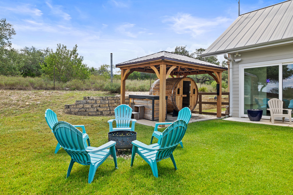 4607 R O Drive Spicewood, TX 78669 - Photo 32 of 40 a view of a chair and table in the patio with a lake view