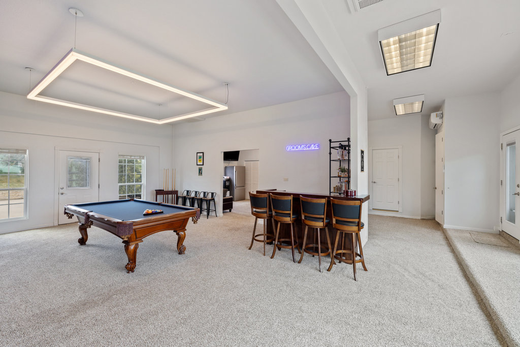 4607 R O Drive Spicewood, TX 78669 - Photo 35 of 40 a living room with furniture a dining table and a bookshelf