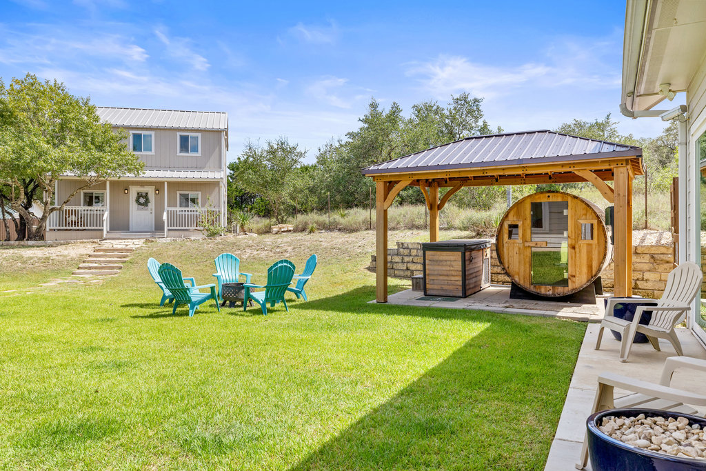 4607 R O Drive Spicewood, TX 78669 - Photo 36 of 40 a view of swimming pool with lawn chairs and a yard