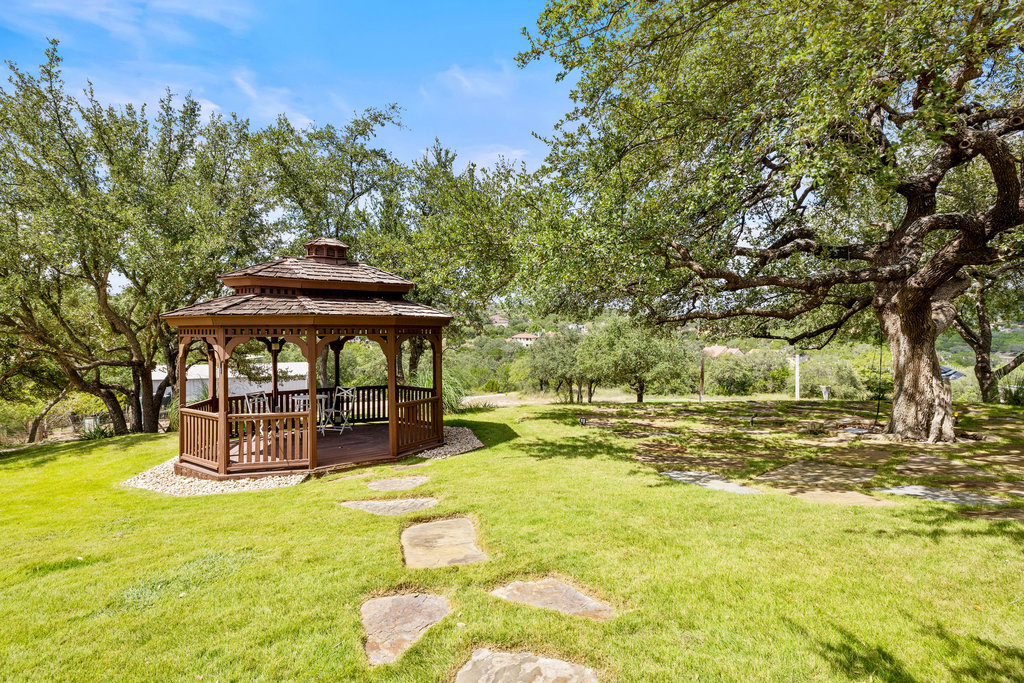 4607 R O Drive Spicewood, TX 78669 - Photo 37 of 40 a view of a backyard with a table and chairs