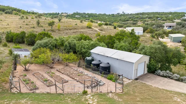 a view of a terrace with a garden and trees