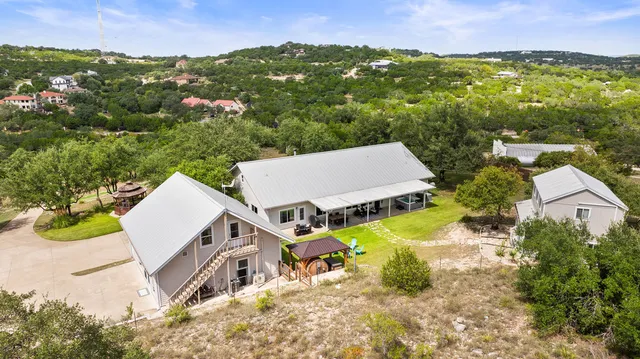 an aerial view of residential houses with outdoor space and swimming pool