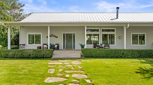 a front view of a house with a yard