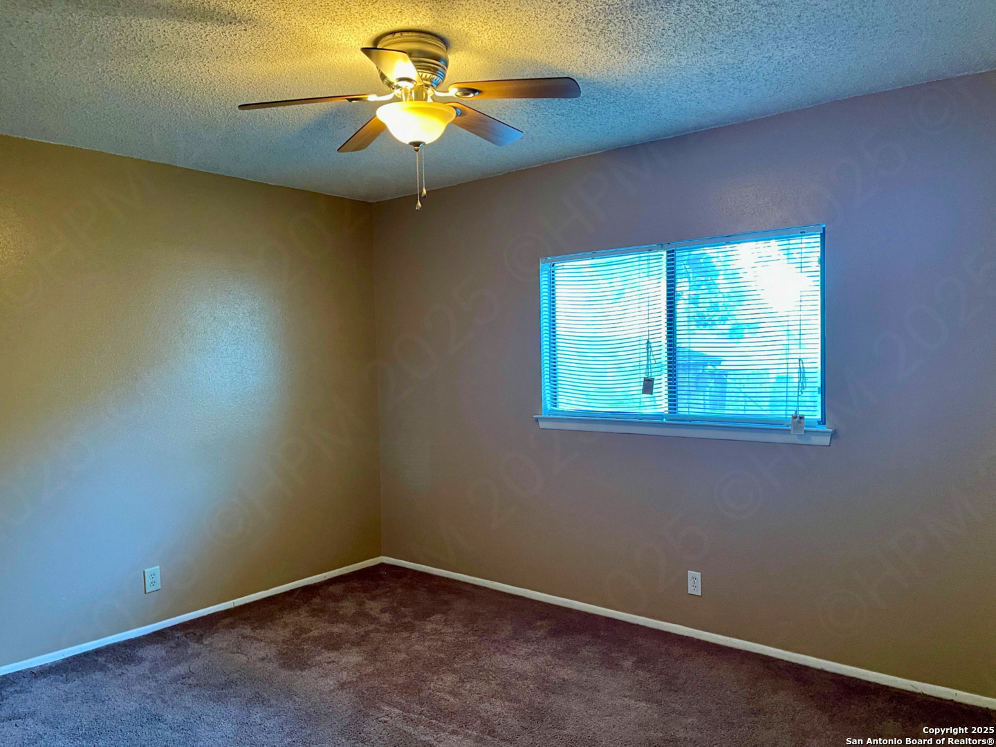 7318 Hunters Raven San Antonio, TX 78249 - Photo 13 of 18 an empty room with a window and a fan