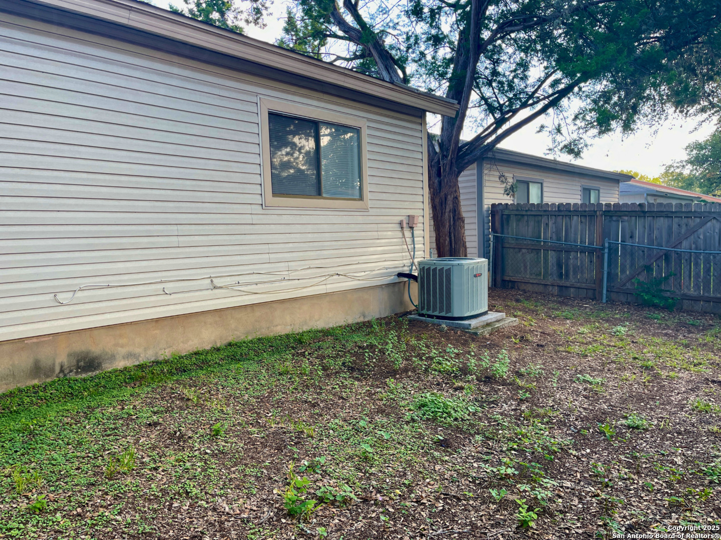7318 Hunters Raven San Antonio, TX 78249 - Photo 16 of 18 a view of a backyard with wooden fence