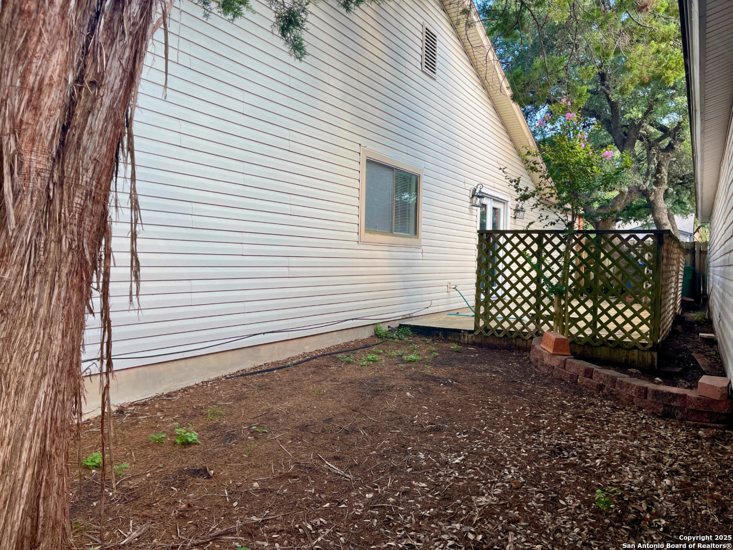 7318 Hunters Raven San Antonio, TX 78249 - Photo 17 of 18 a view of a yard with wooden fence