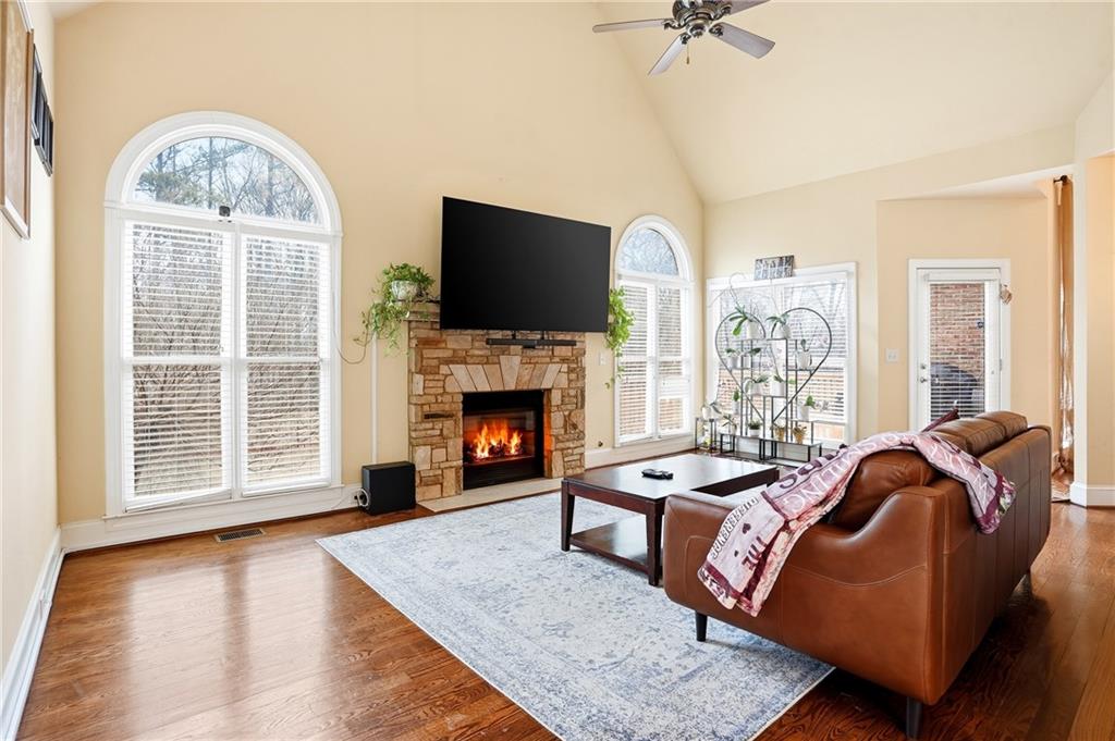 930 Old Tucker Road Stone Mountain, GA 30087 - Photo 21 of 47 a living room with furniture a flat screen tv and a fireplace