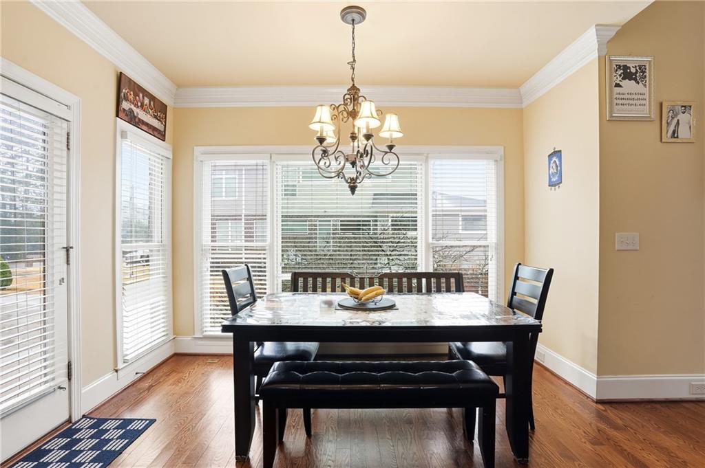 930 Old Tucker Road Stone Mountain, GA 30087 - Photo 23 of 47 a dining room with furniture a chandelier and wooden floor