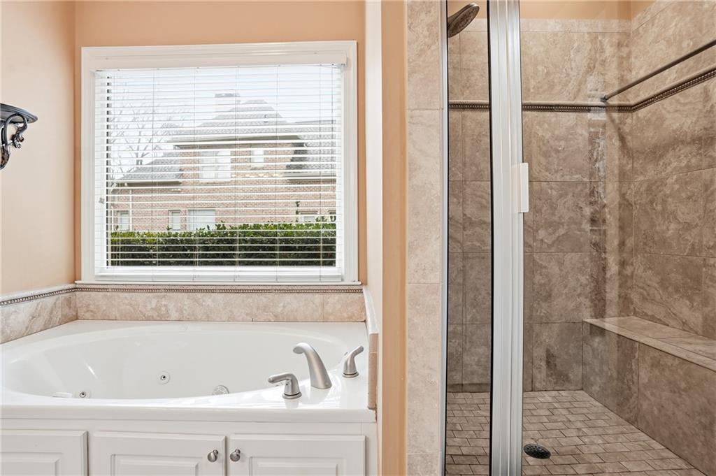 930 Old Tucker Road Stone Mountain, GA 30087 - Photo 30 of 47 a bathroom with a bathtub and a shower