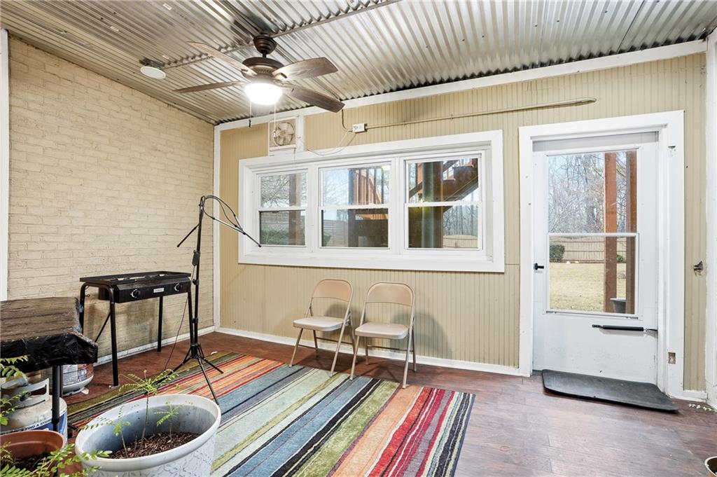930 Old Tucker Road Stone Mountain, GA 30087 - Photo 34 of 47 a living room with furniture and a floor to ceiling window