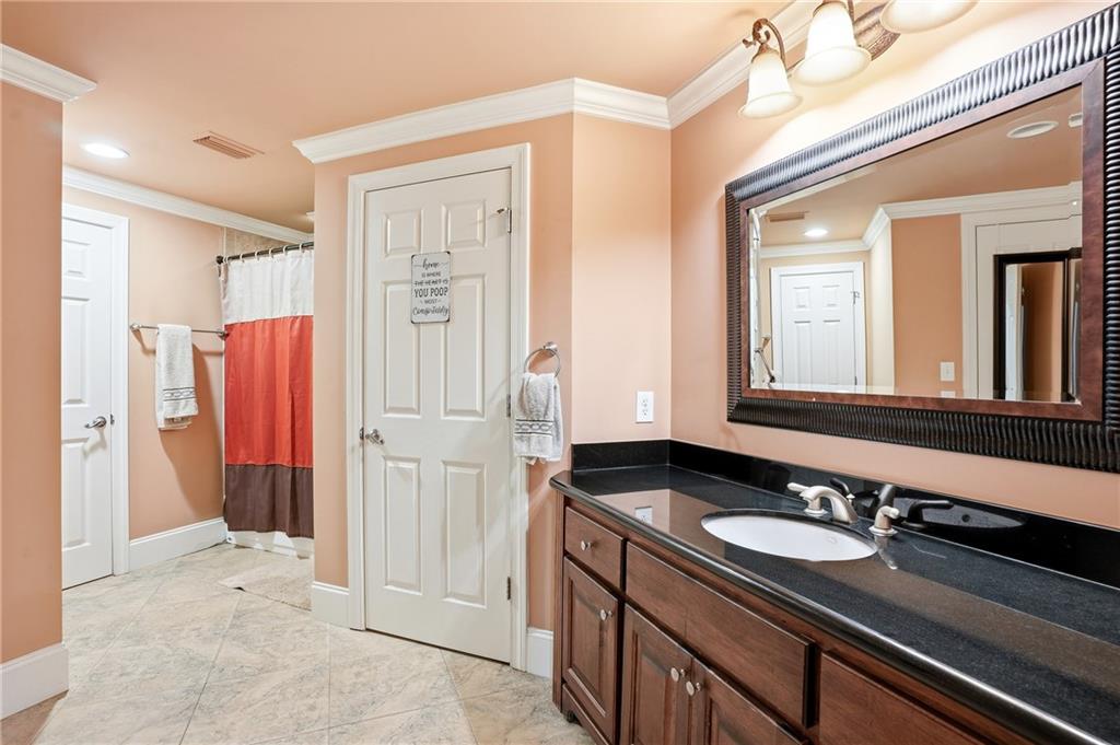 930 Old Tucker Road Stone Mountain, GA 30087 - Photo 35 of 47 a bathroom with a sink and a mirror