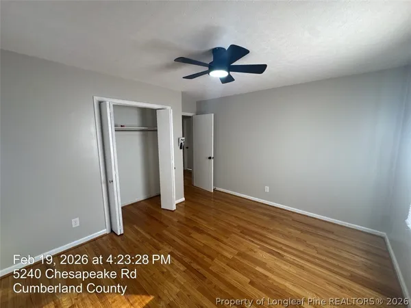 a view of an empty room with a ceiling fan