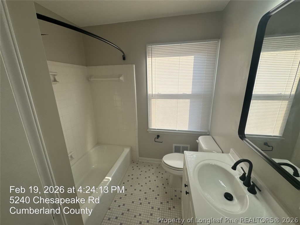 5240 Chesapeake Road Fayetteville, NC 28311 - Photo 16 of 20 a bathroom with a sink a window and a shower