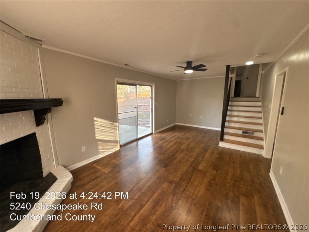 5240 Chesapeake Road Fayetteville, NC 28311 - Photo 18 of 20 a view of a livingroom with wooden floor and a ceiling fan