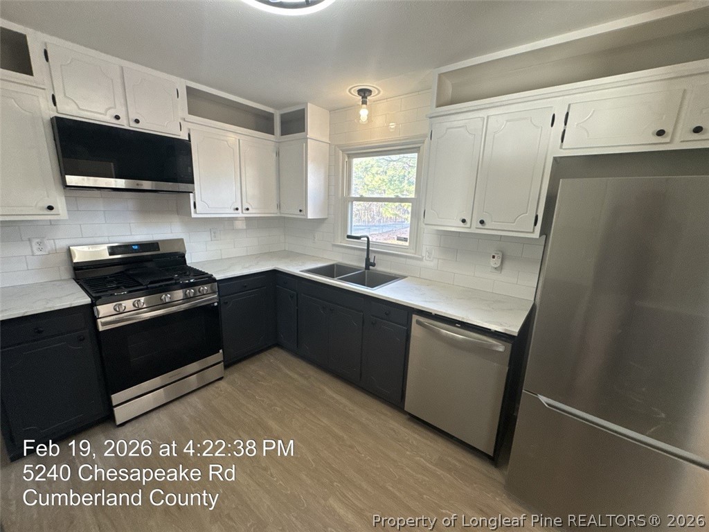 5240 Chesapeake Road Fayetteville, NC 28311 - Photo 8 of 20 a kitchen with a sink appliances and cabinets