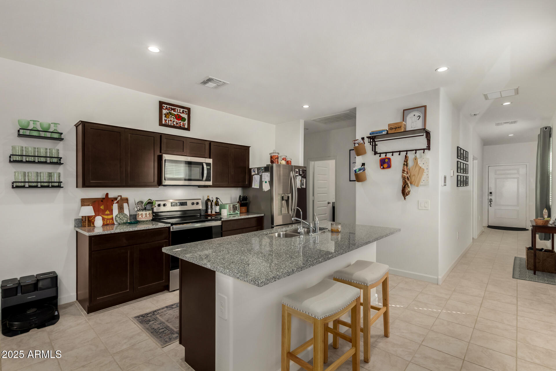 3226 West Stanton Avenue Apache Junction, AZ 85120 - Photo 12 of 34 a kitchen with granite countertop a sink appliances and cabinets