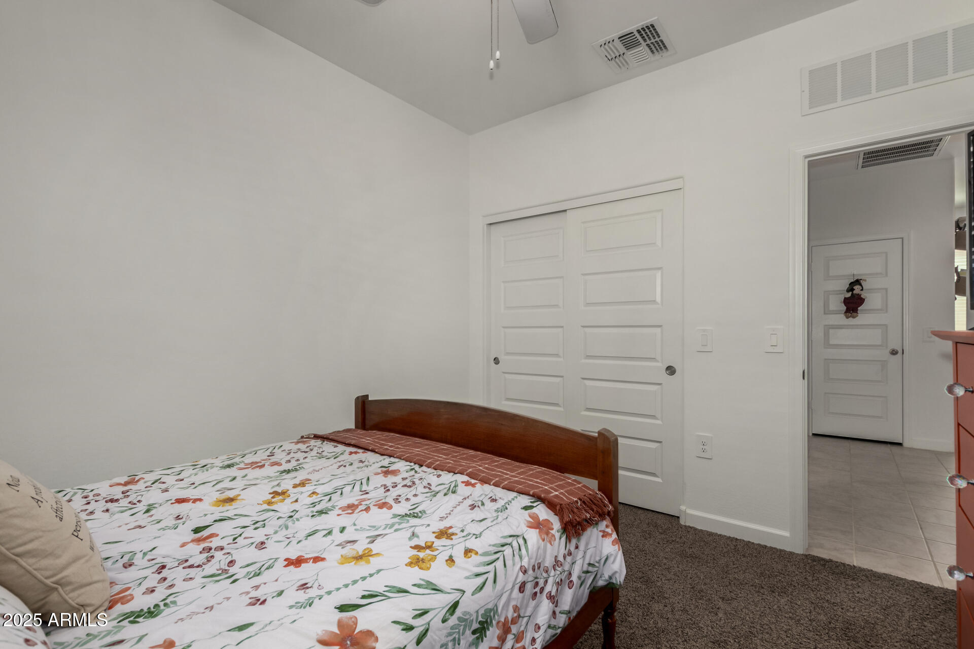3226 West Stanton Avenue Apache Junction, AZ 85120 - Photo 21 of 34 a bedroom with a bed and a rug