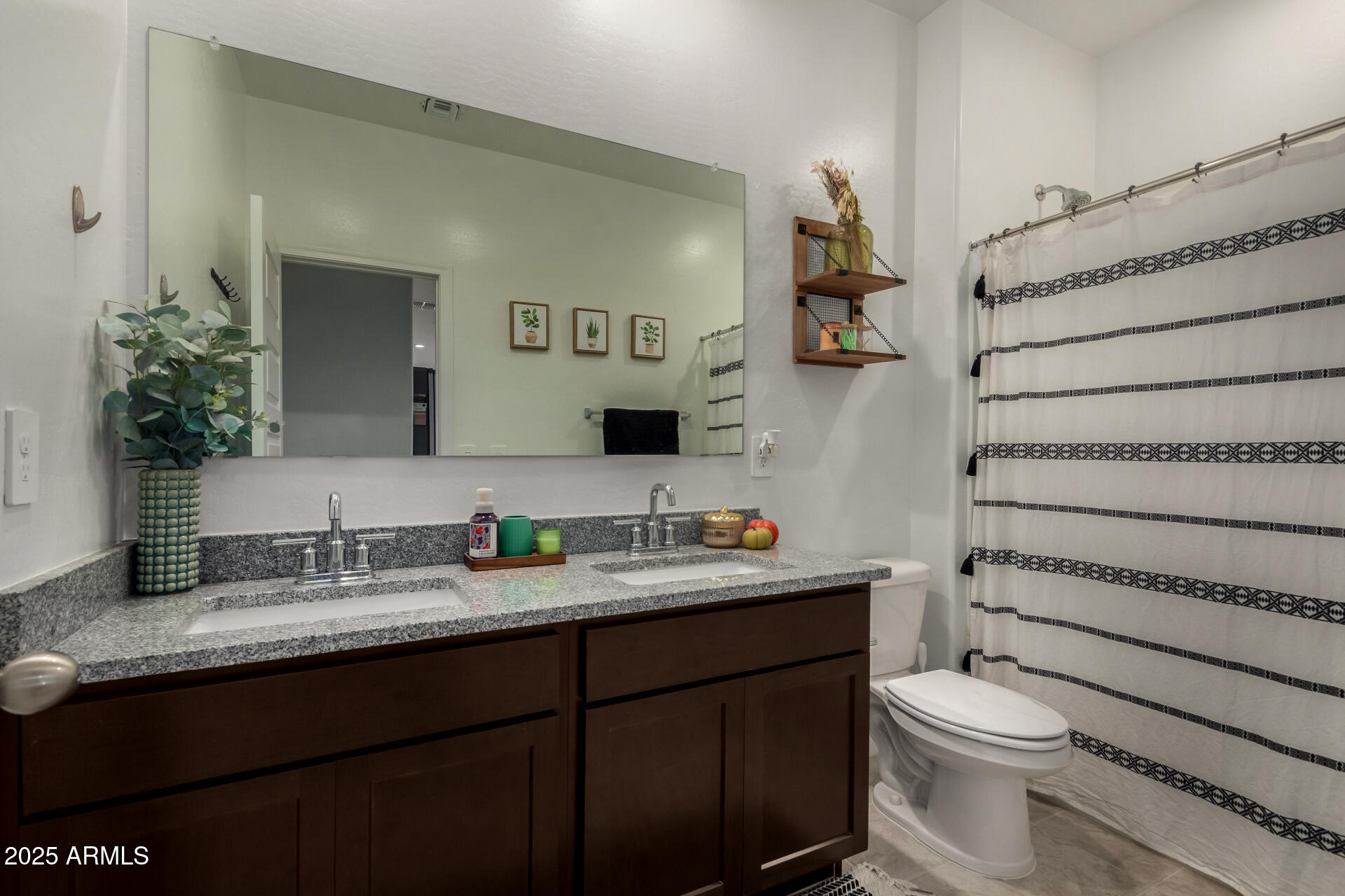 3226 West Stanton Avenue Apache Junction, AZ 85120 - Photo 25 of 34 a bathroom with a granite countertop toilet sink and mirror