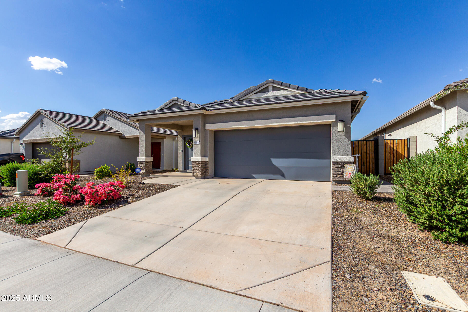 3226 West Stanton Avenue Apache Junction, AZ 85120 - Photo 3 of 34 a front view of a house with a garage
