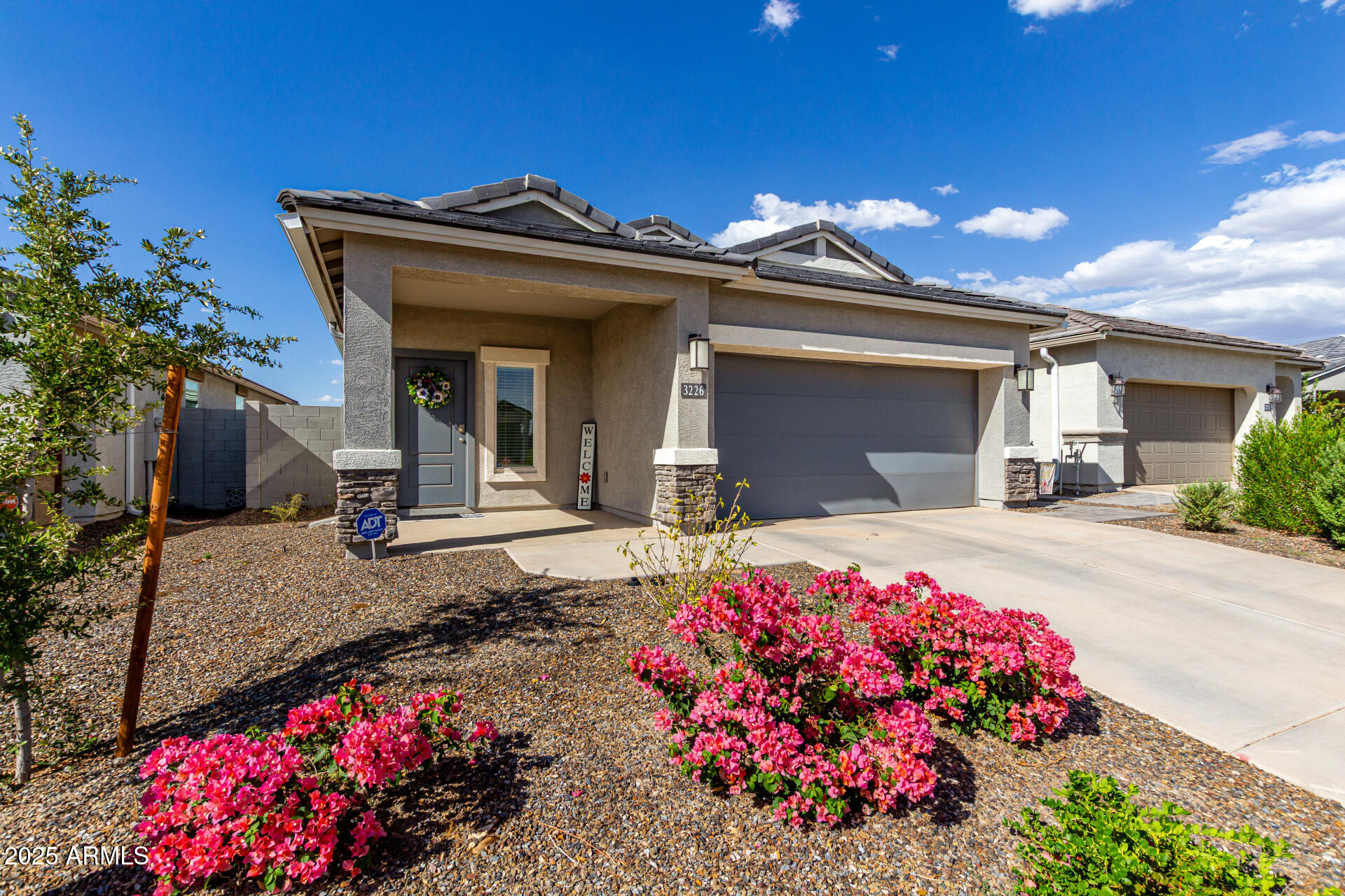 3226 West Stanton Avenue Apache Junction, AZ 85120 - Photo 5 of 34 a view of a house with a flower garden