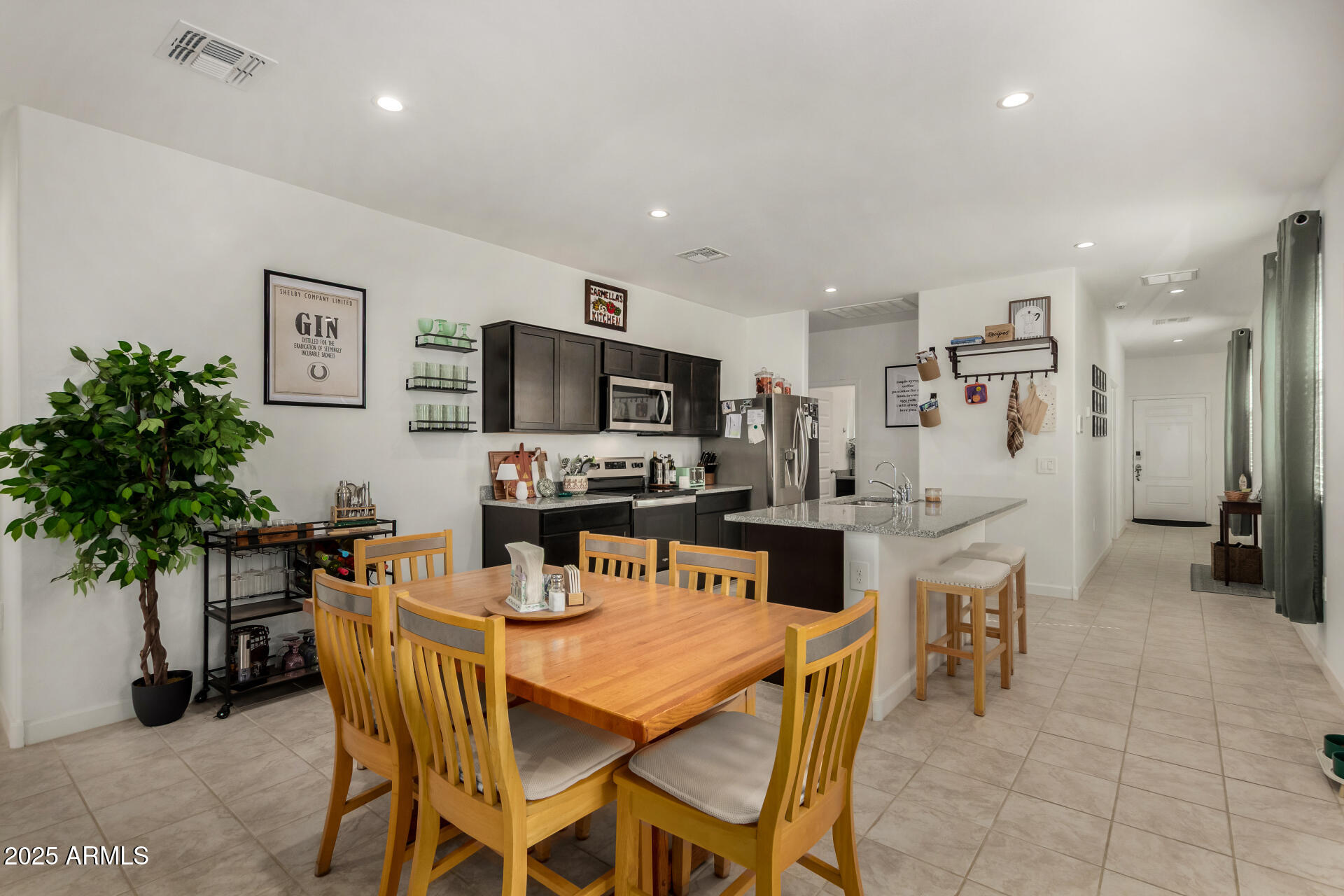 3226 West Stanton Avenue Apache Junction, AZ 85120 - Photo 10 of 34 a view of a dining room with furniture and potted plant