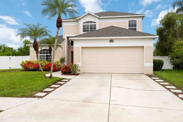 a front view of house with yard and trees around