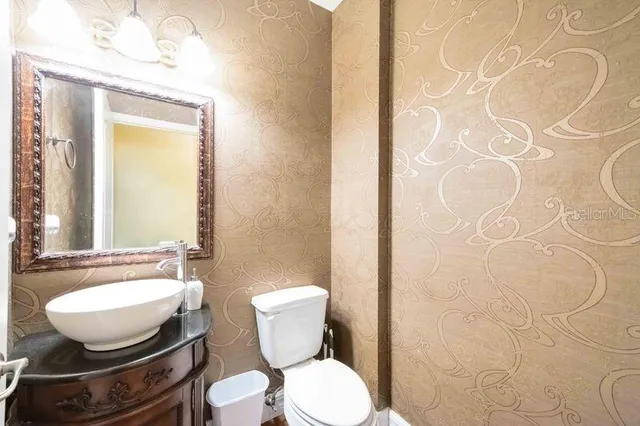 a bathroom with a toilet and a mirror