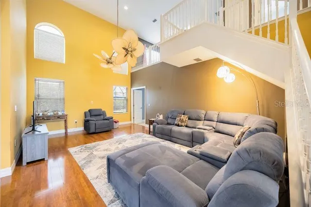 a living room with furniture and a chandelier
