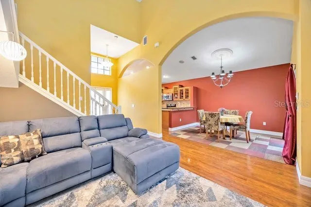 a living room with furniture and wooden floor