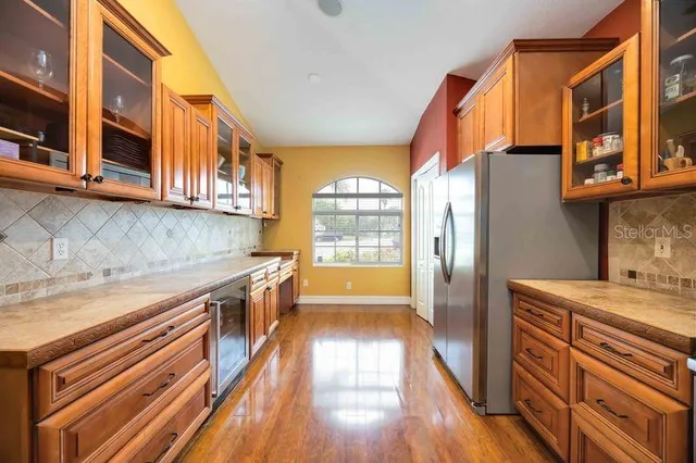 a kitchen with stainless steel appliances granite countertop a stove a sink and a refrigerator