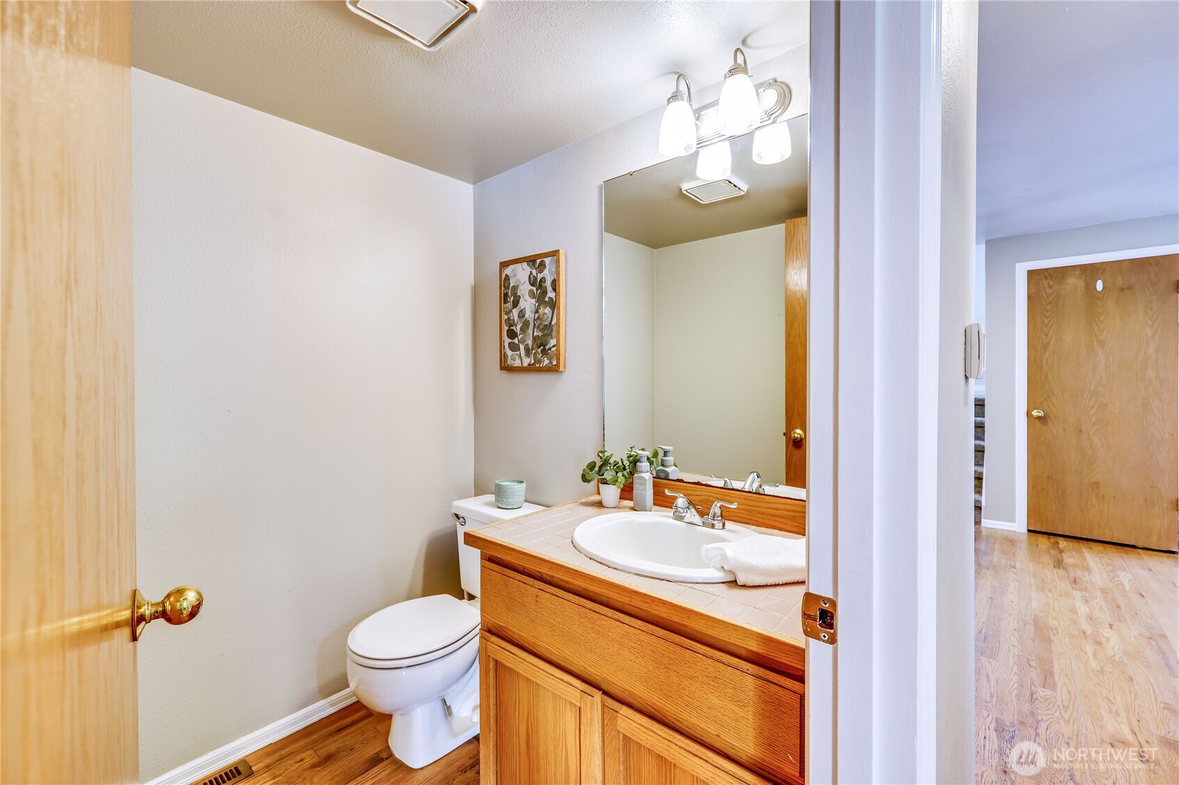 12281 Ridgepoint Circle Northwest Silverdale, WA 98383 - Photo 18 of 37 a bathroom with a sink vanity mirror and toilet