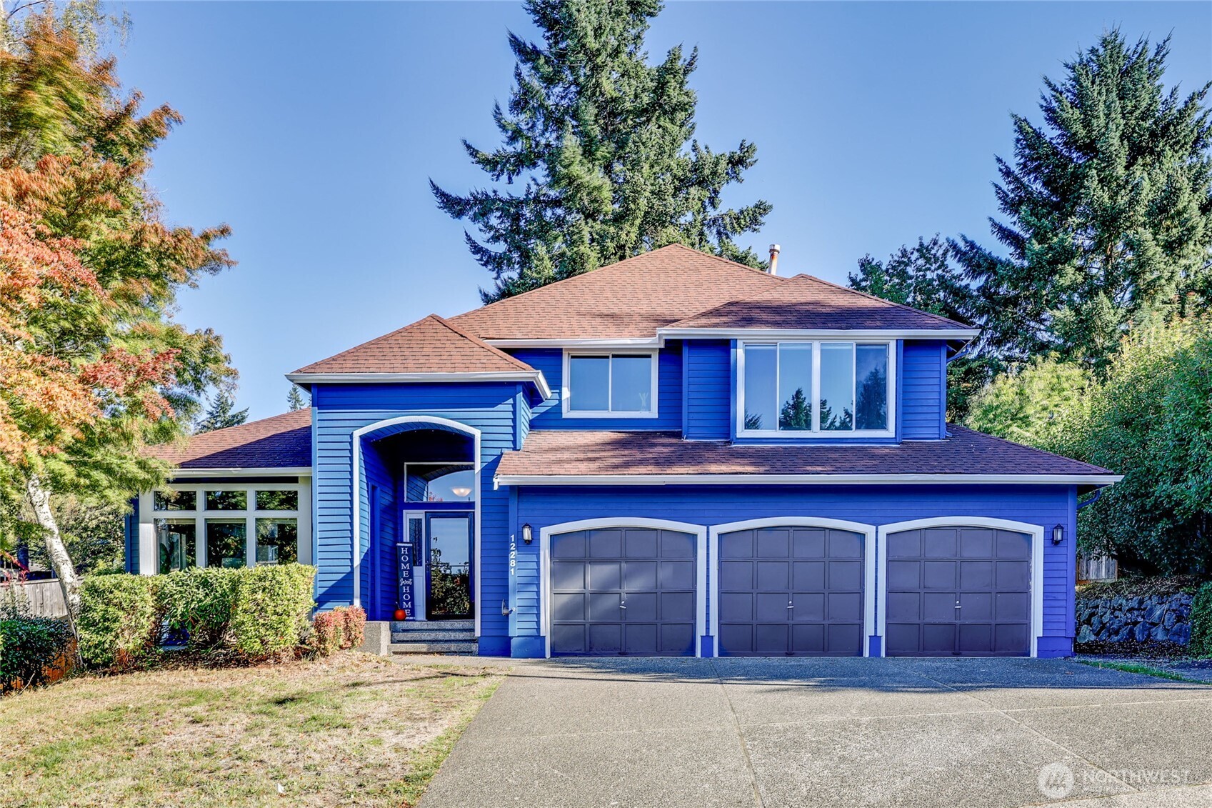 12281 Ridgepoint Circle Northwest Silverdale, WA 98383 - Photo 2 of 37 a front view of a house with garden