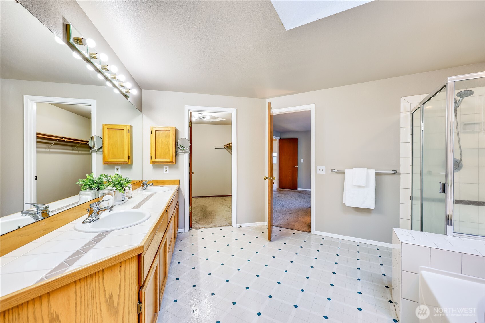 12281 Ridgepoint Circle Northwest Silverdale, WA 98383 - Photo 22 of 37 a bathroom with a sink double vanity mirror and a bathtub