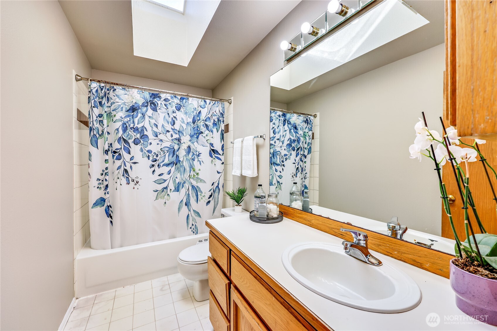 12281 Ridgepoint Circle Northwest Silverdale, WA 98383 - Photo 26 of 37 a bathroom with a sink a toilet and shower curtain