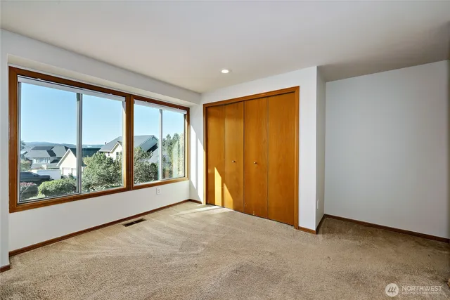 an aerial view of a house with a yard and lake view
