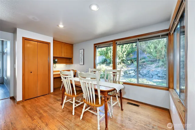 a view of a dining room with furniture and wooden floor